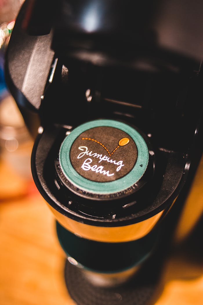 Close-up of a single-serve coffee machine with Jumping Bean capsule.